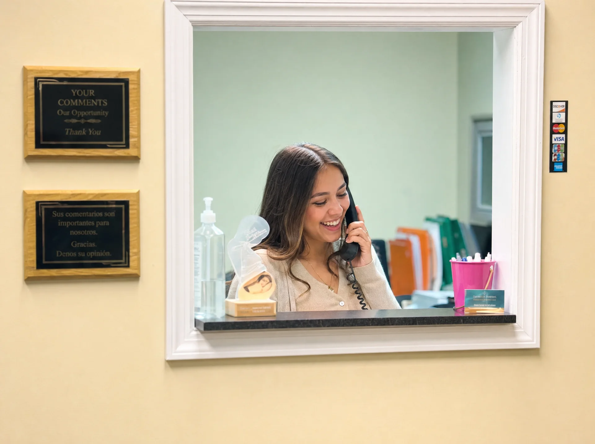 A receptionist on the phone at the Precious Life Medical Services front desk in Avenel, NJ